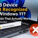 Laptop screen showing a Windows 11 background and text reading 'USB Device Not Recognized in Windows 11? 11 Fixes That Actually Work.' A digital error notification pops up over the keyboard, and a red circle with a white 'X' overlays a USB drive plugged into the side port.